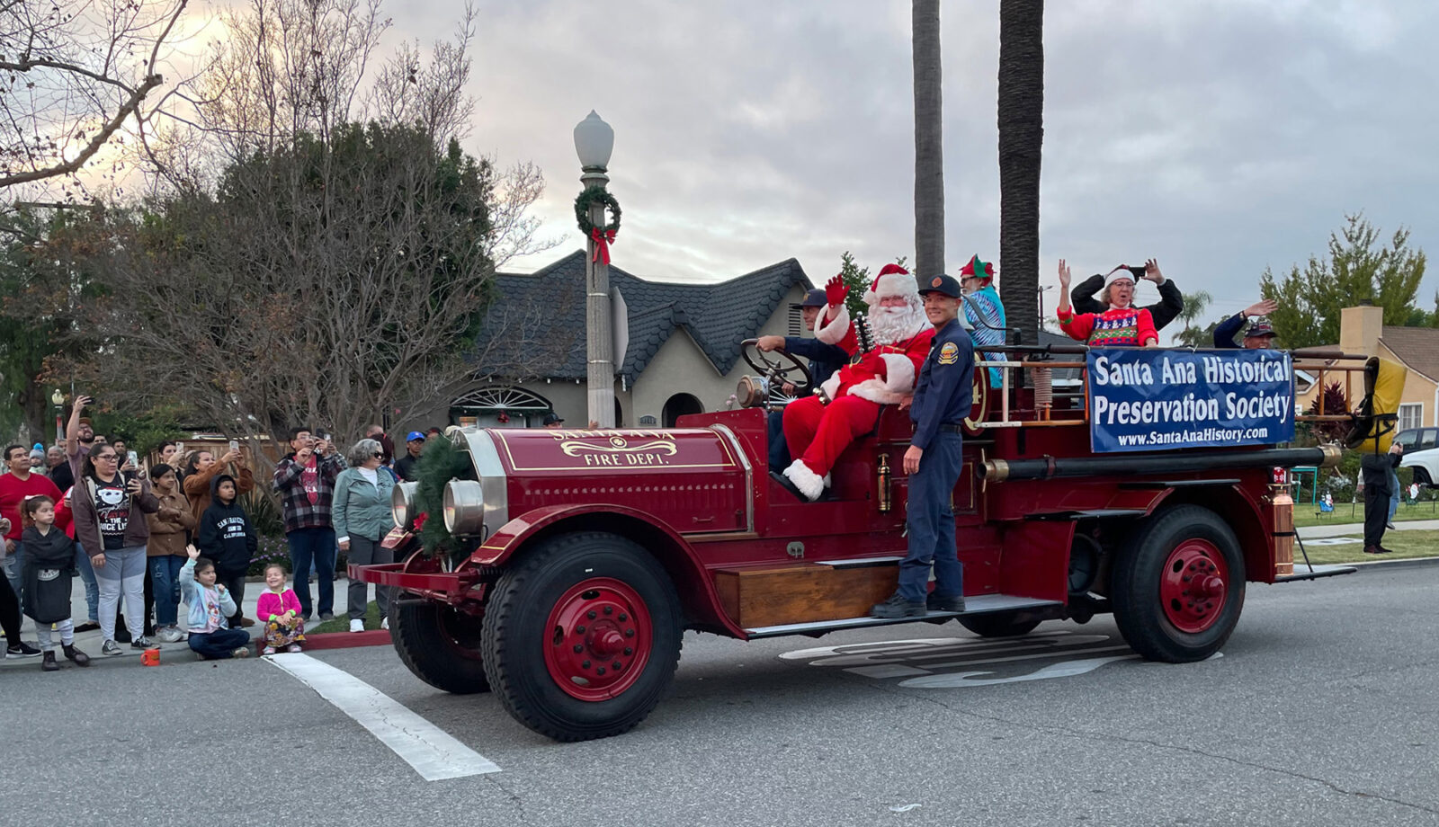 Santa rides in the vintage Seagrave fire truck in the Wilshire Square holiday parade